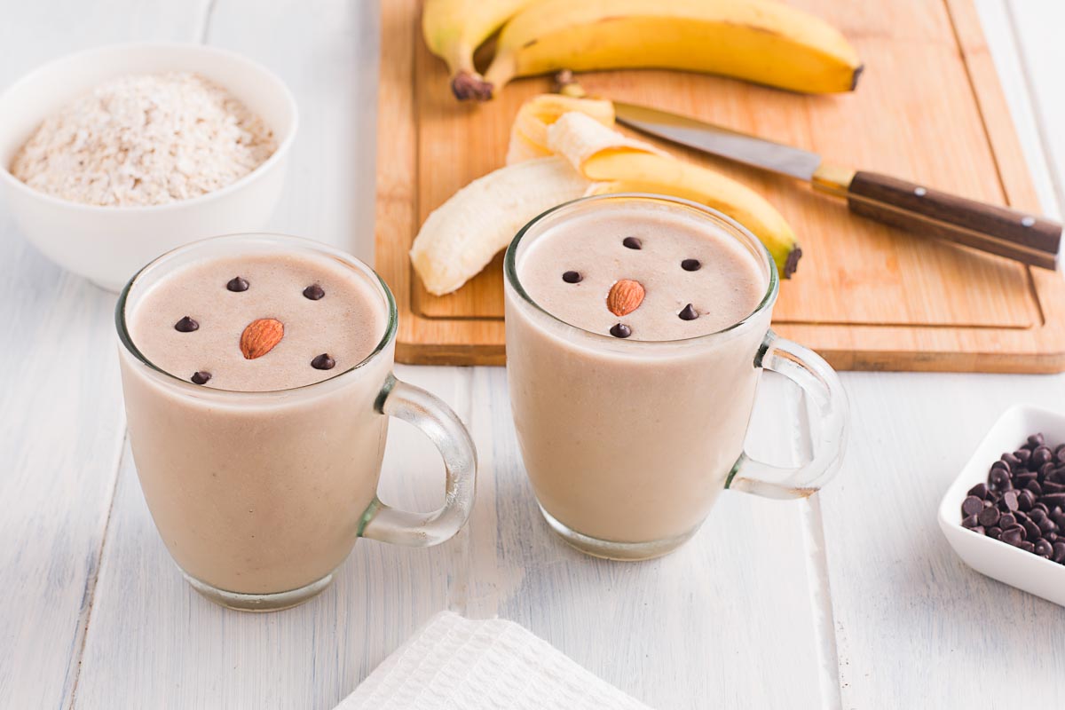Two of the finished Peanut Butter Banana Smoothies in glasses.