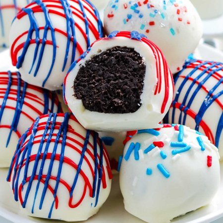 A close up picture of Oreo cream cheese truffles with a bite taken out of one.