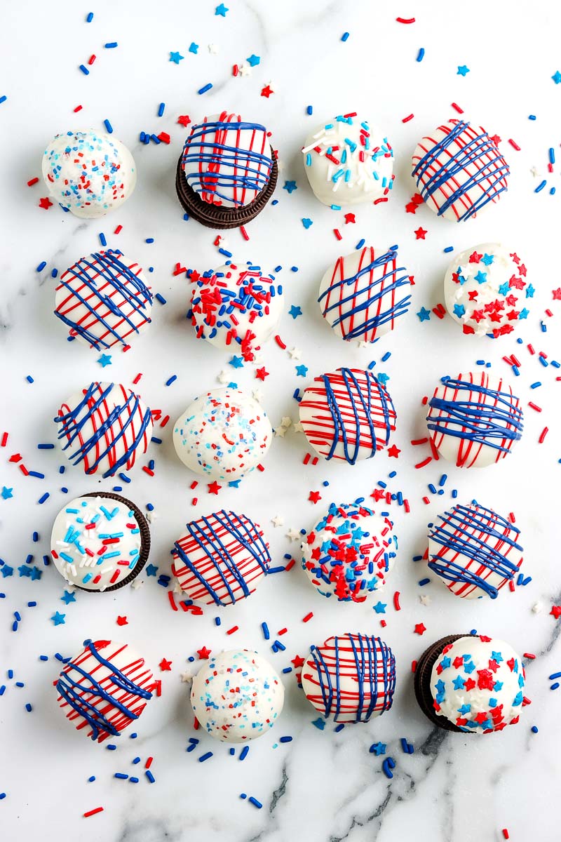 n overhead picture of rows of Patriotic Oreo Cream Cheese Truffles on a white platter.