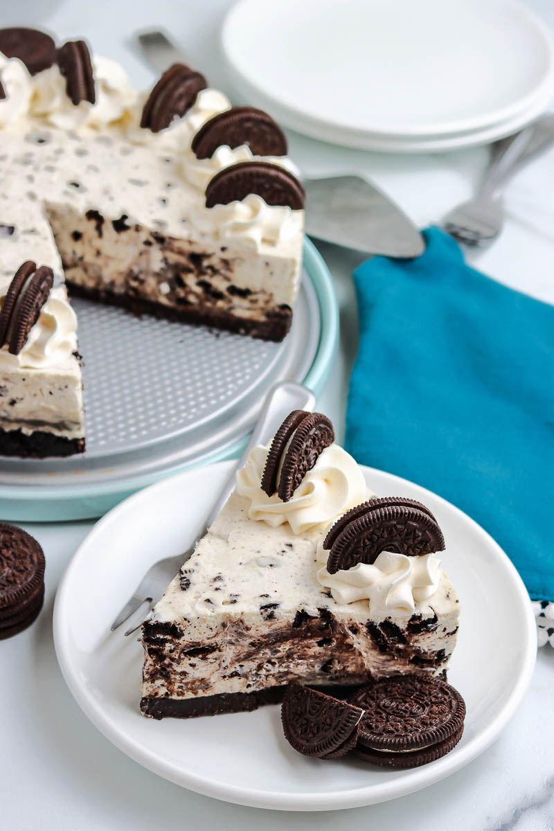 A slice of No Bake Oreo Cheesecake on a white plate.