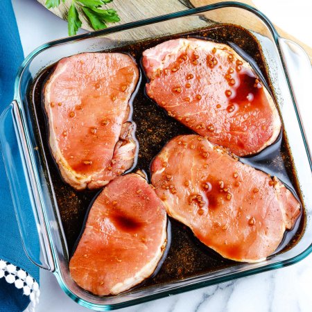 AN overhead picture of pork chops marinating.