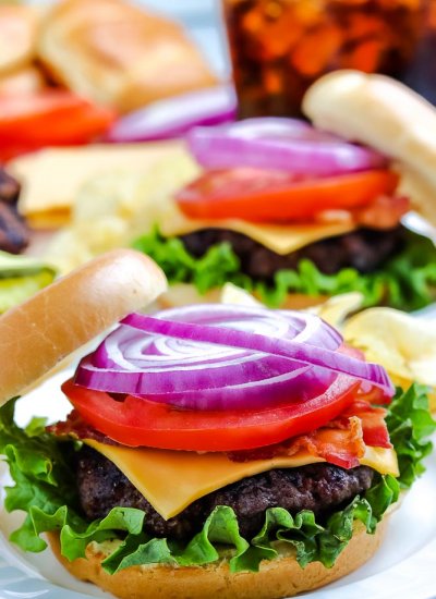 A grilled hamburger on a white plate.