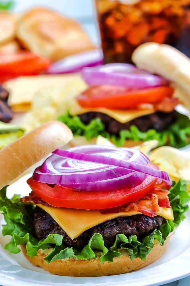 A grilled hamburger on a white plate.