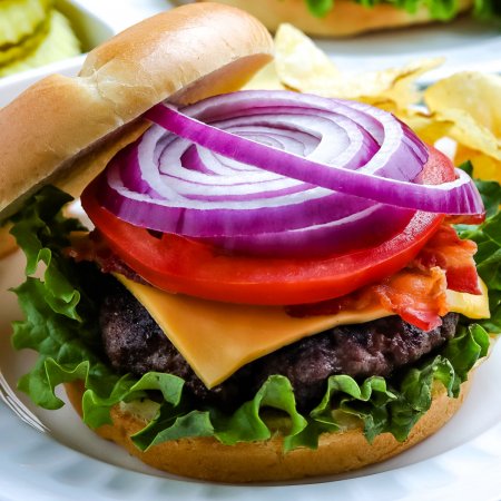 A close up picture of a finished grilled burger.