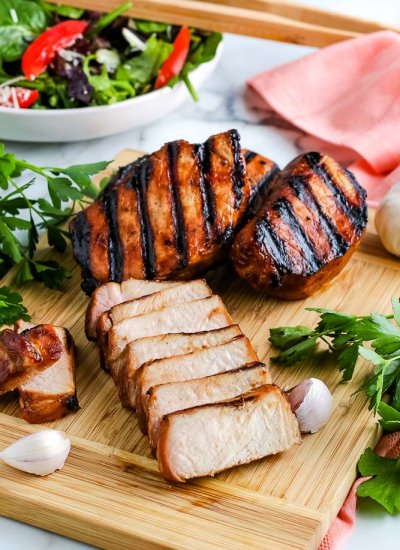 A cooked pork chop cut into slices.