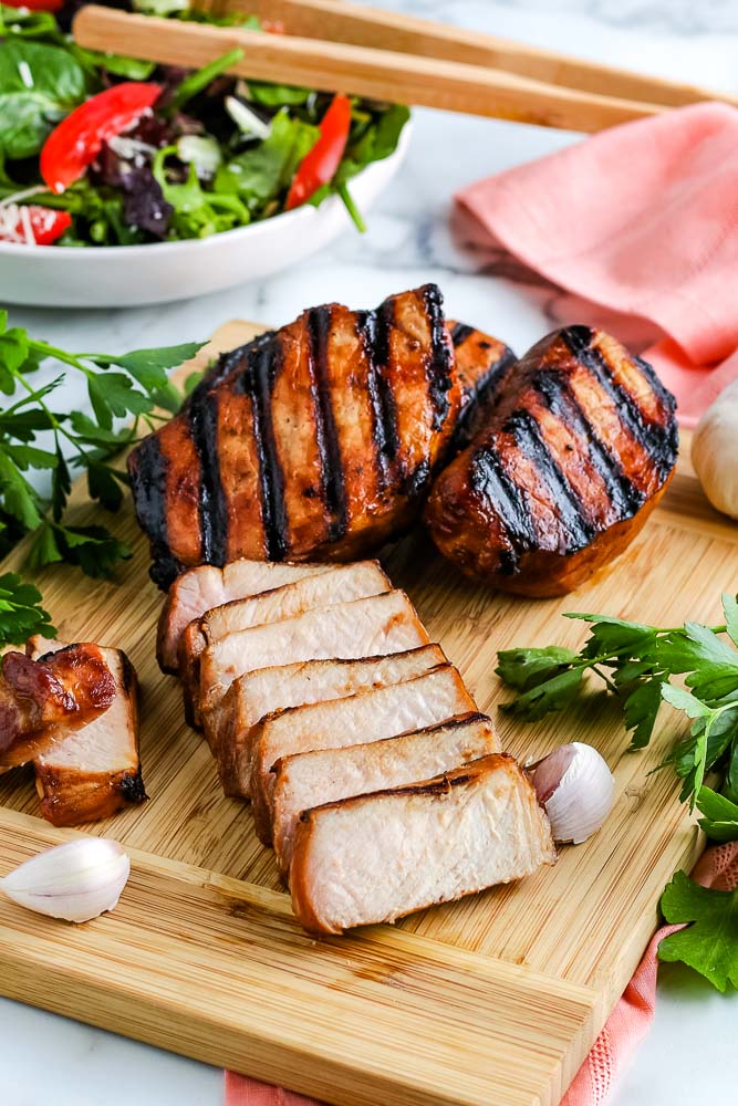 A cooked pork chop cut into slices.