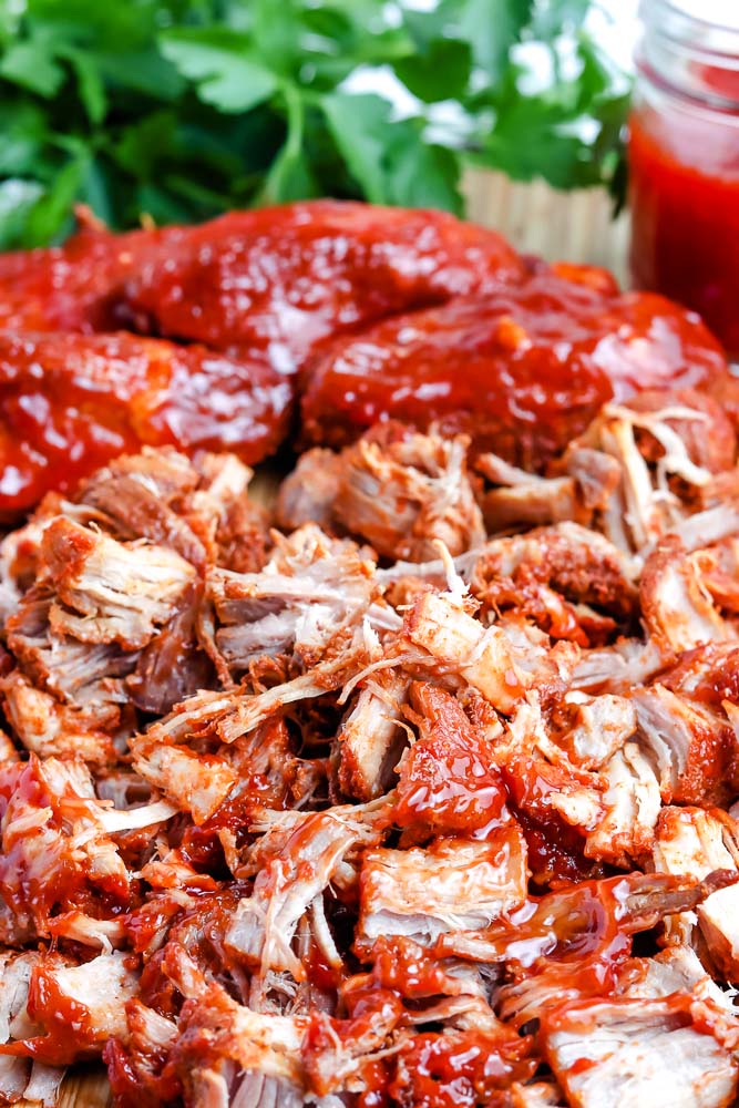 Boneless ribs shredded on a wooden cutting boars.