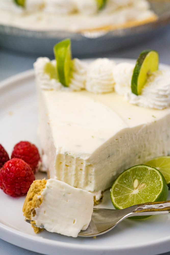 A slice of no-bake key lime pie on a white plate.
