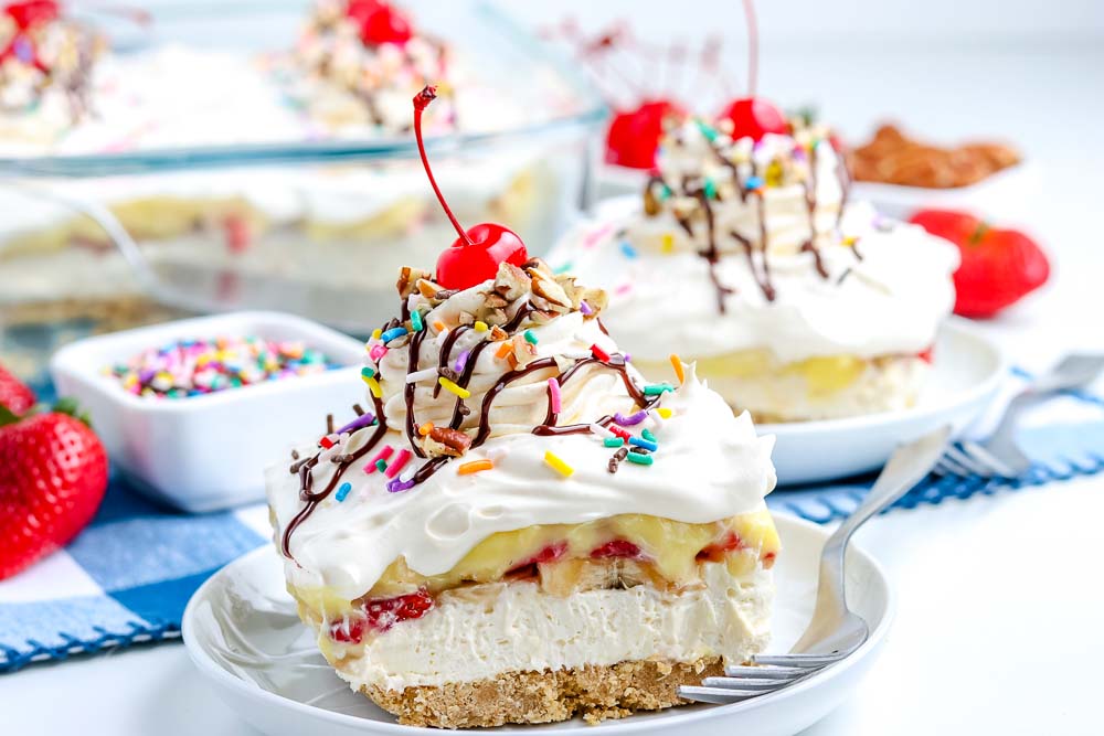 A piece of banana split cake on a white plate.