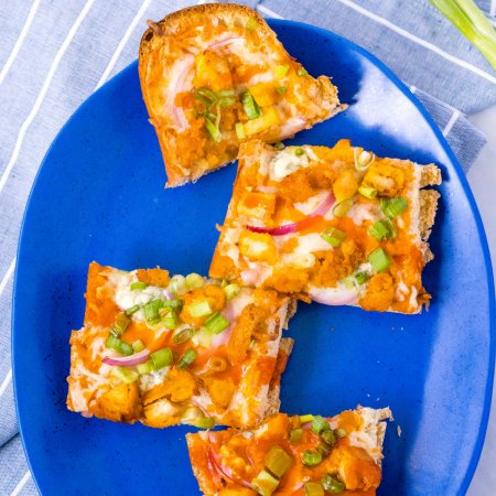 An overhead picture of piece of the french bread pizza on a blue plate.