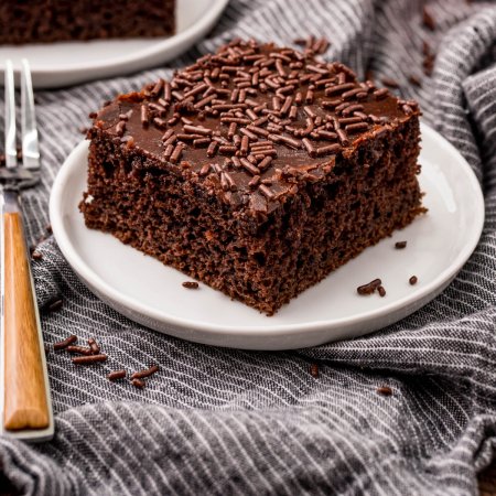 A slice of Dr Pepper Cake on a white plate.
