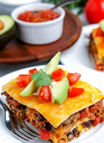 A close up pickets of a slice of Mexican Lasagna made with flour tortillas.