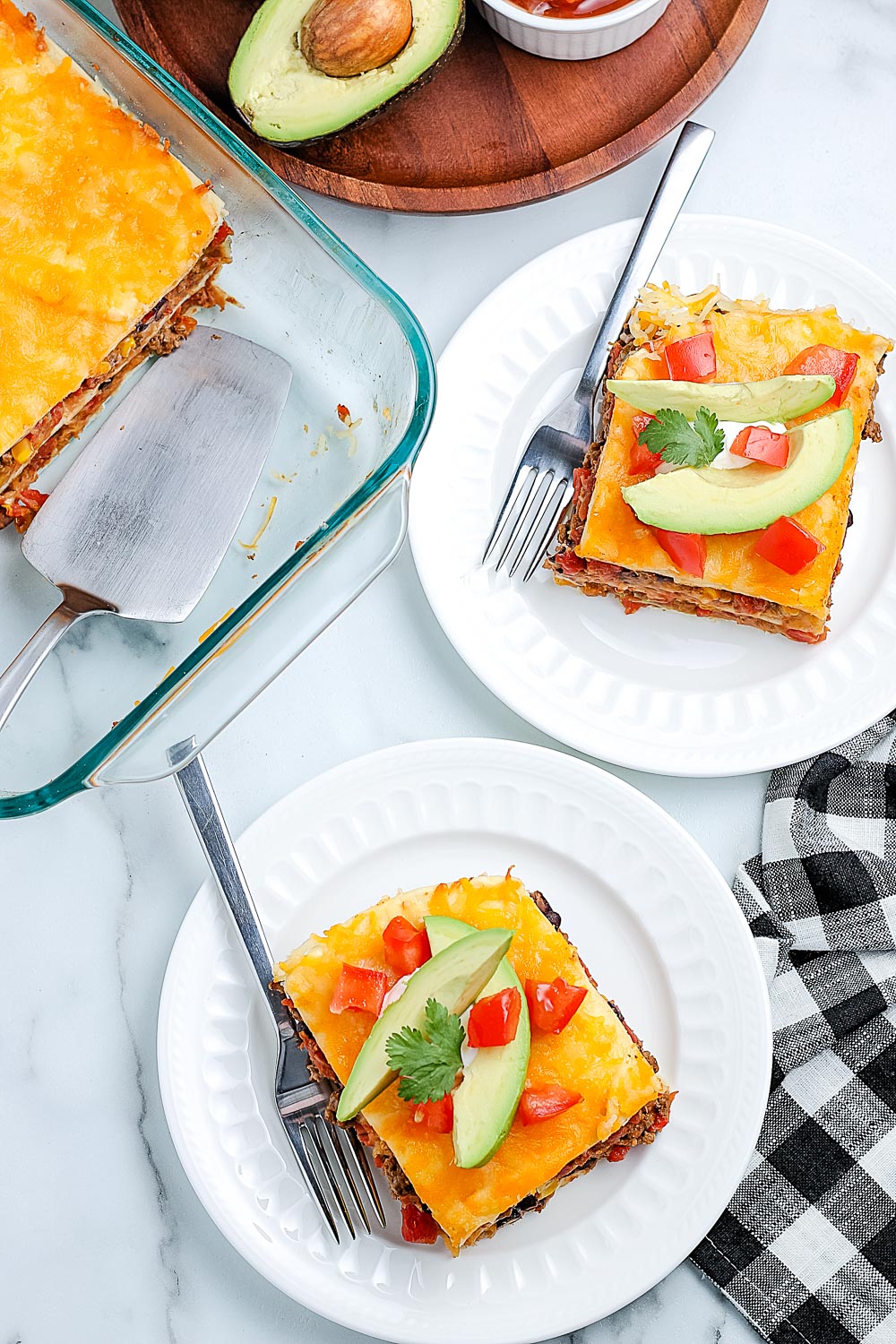 An overhead picture slices of the lasagna on white plates.