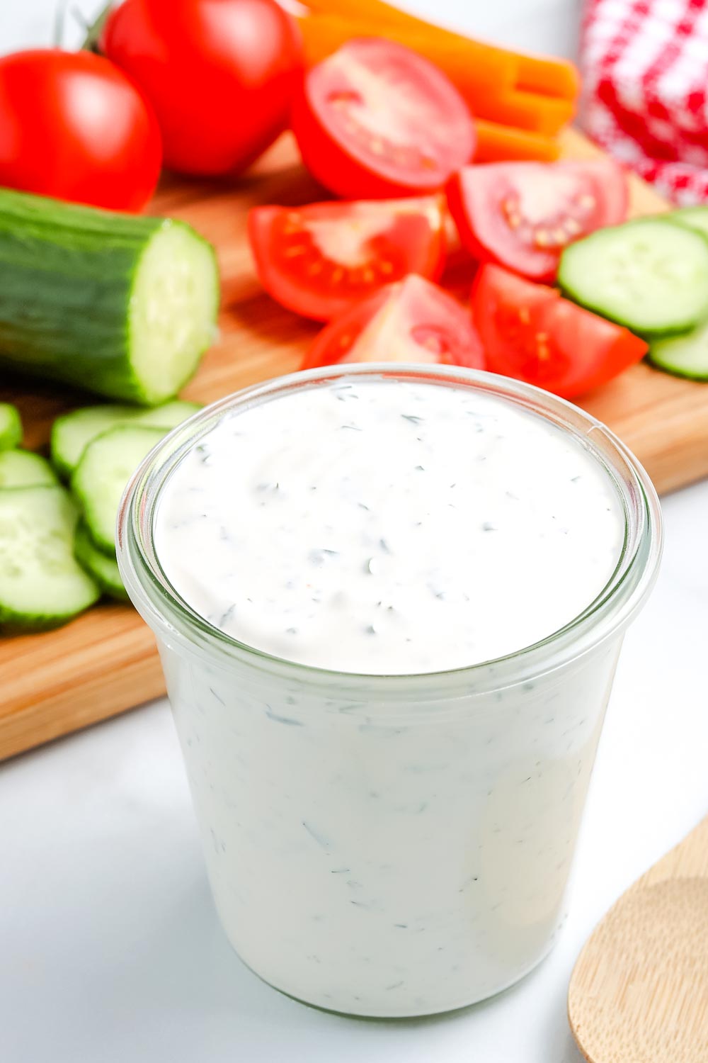 Homemade Ranch Dressing in a clear glass jar.