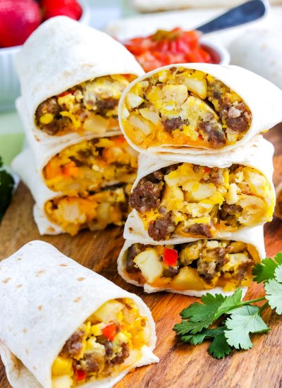 Three Breakfast Burritos cut in half and stacked on top of each other.