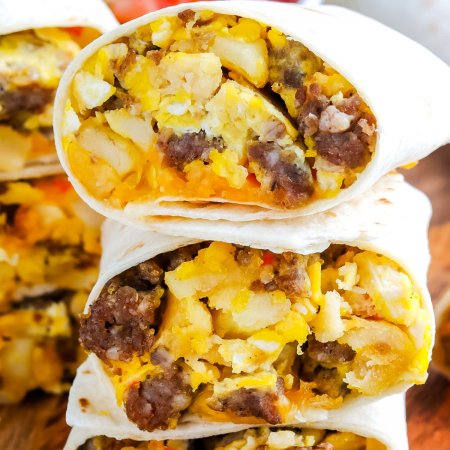 Breakfast Burritos cut in half and stacked on top of each other.