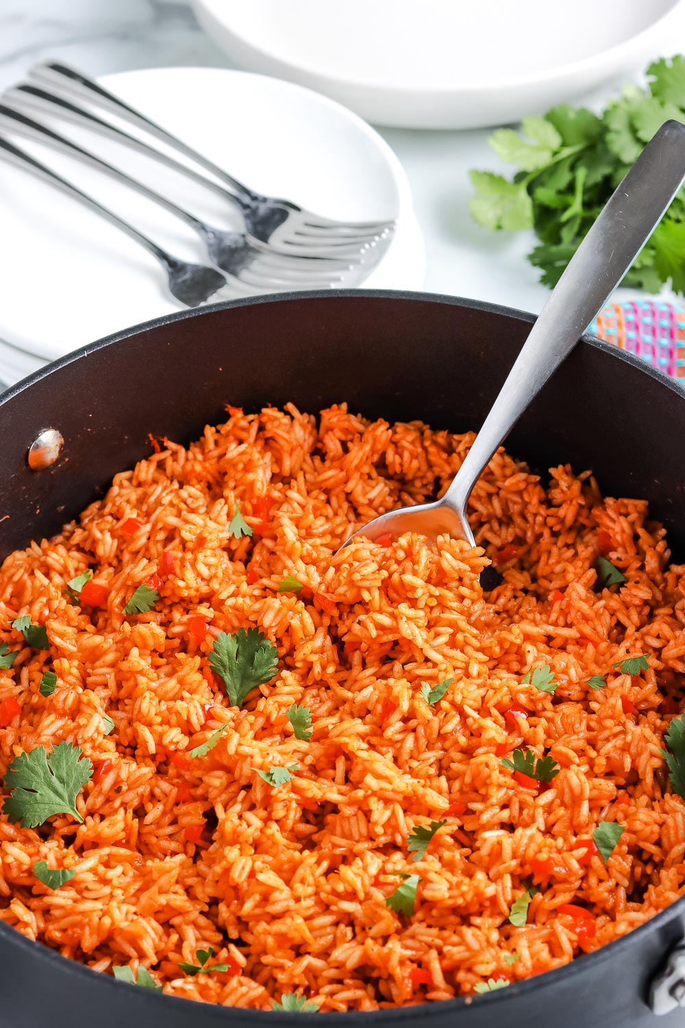 The finished Spanish Rice in a big pan that is garnished with cilantro.