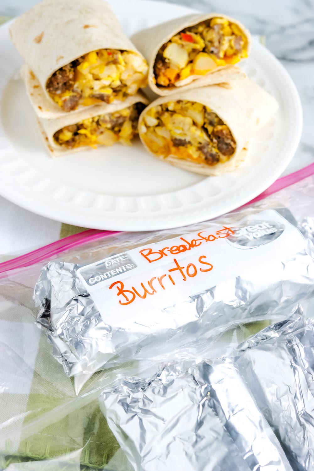 Finished Breakfast Burritos wrapped in foil and placed in a Ziploc bag ready for the freezer.