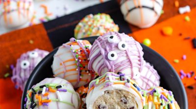 A bowl full of Cookie Dough Balls decorated for Halloween.