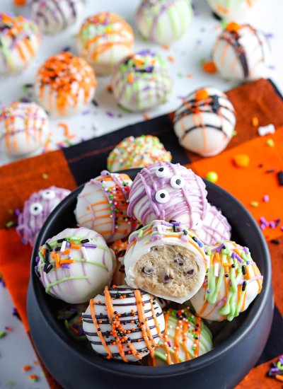 A bowl full of Cookie Dough Balls decorated for Halloween.