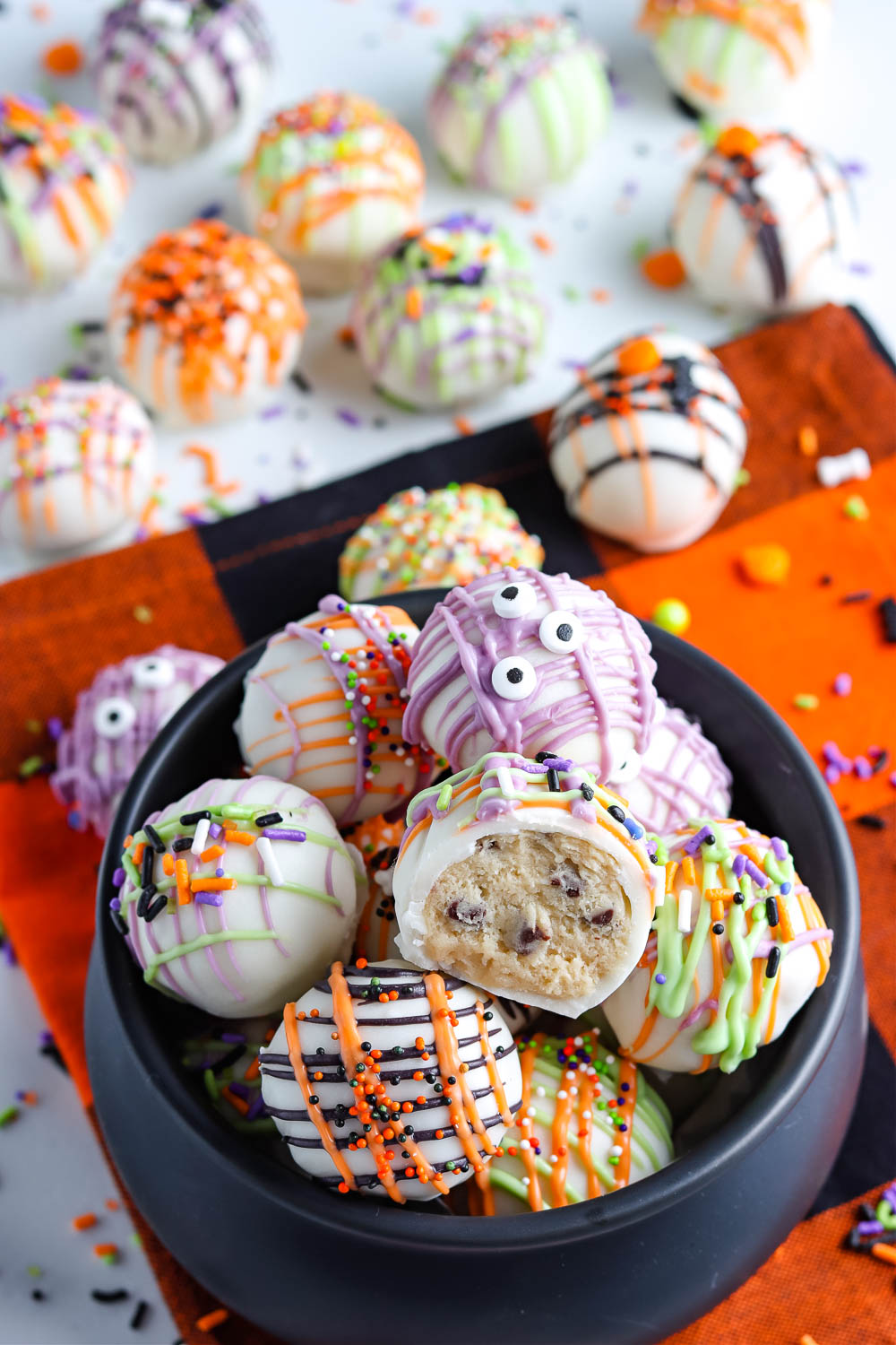 A bowl full of Cookie Dough Balls decorated for Halloween. 