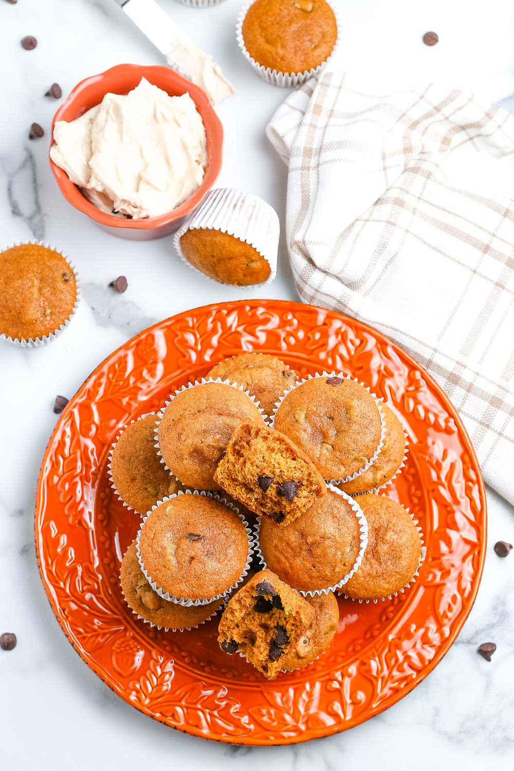An overhead picture of a plate of the finished Pumpkin Chocolate Chip Muffins.