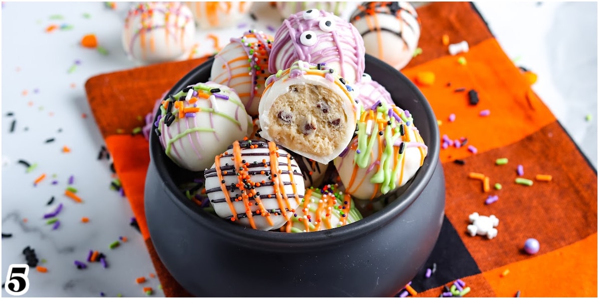 The decorated truffles in a serving bowl with a bite taken out of one so you can see the interior.