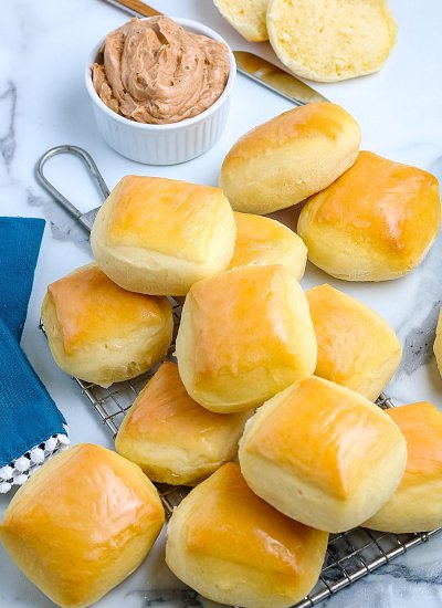An overhead picture of the finished Copycat Texas Roadhouse Rolls with some cinnamon honey butter.