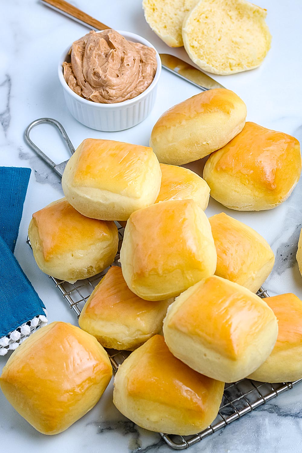 An overhead picture of the finished Copycat Texas Roadhouse Rolls with some cinnamon honey butter.