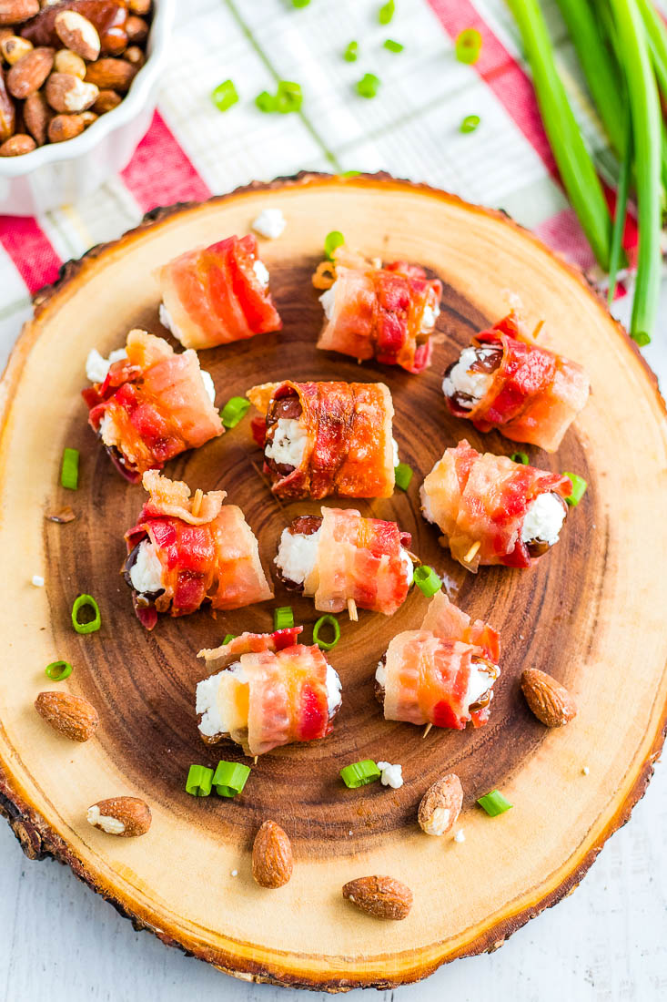 An overhead picture of the finished Bacon Wrapped Dates on a wooden serving tray.