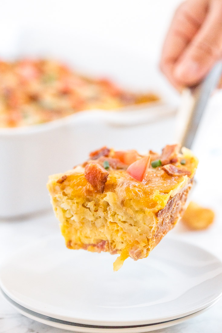 A piece of Tater Tot Breakfast Casserole on a serving spatula.