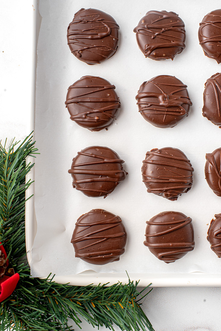 A close up picture of the finished Peppermint Patty Candy recipe in a baking sheet after the have chilled.