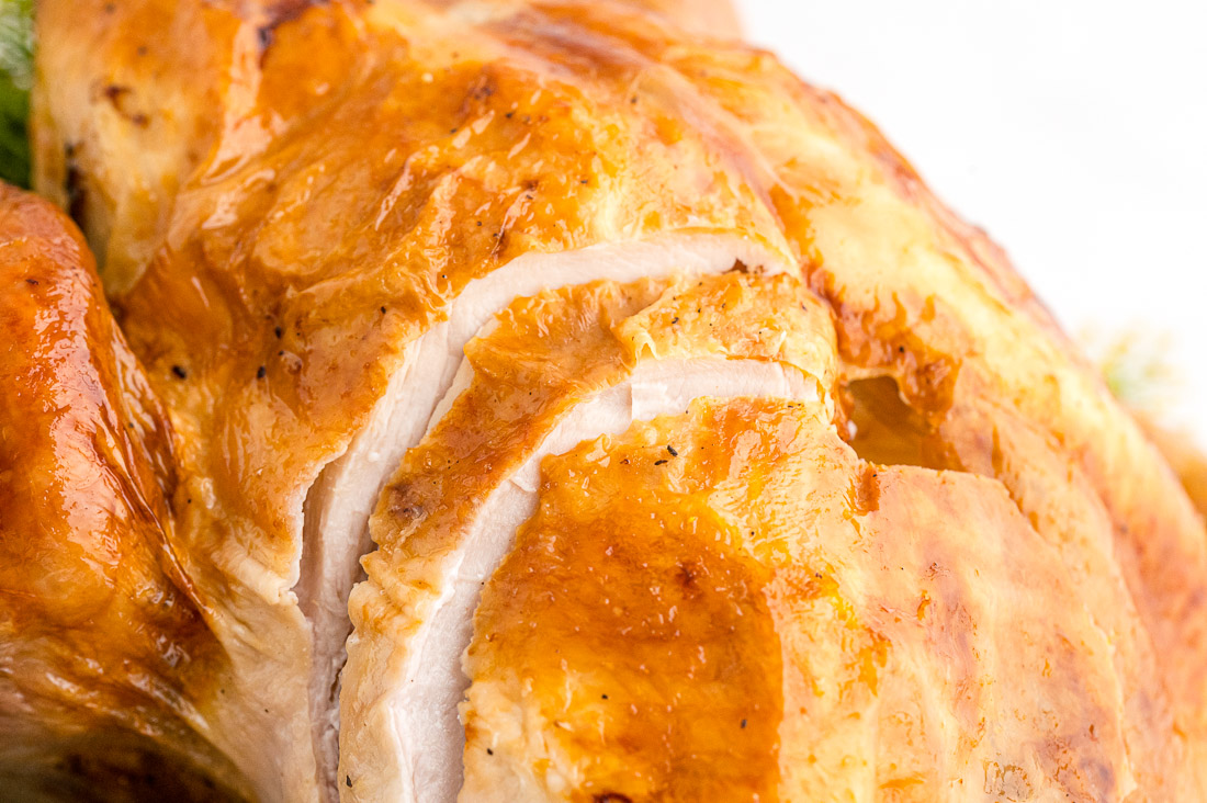 The finished roast turkey with slices in it.