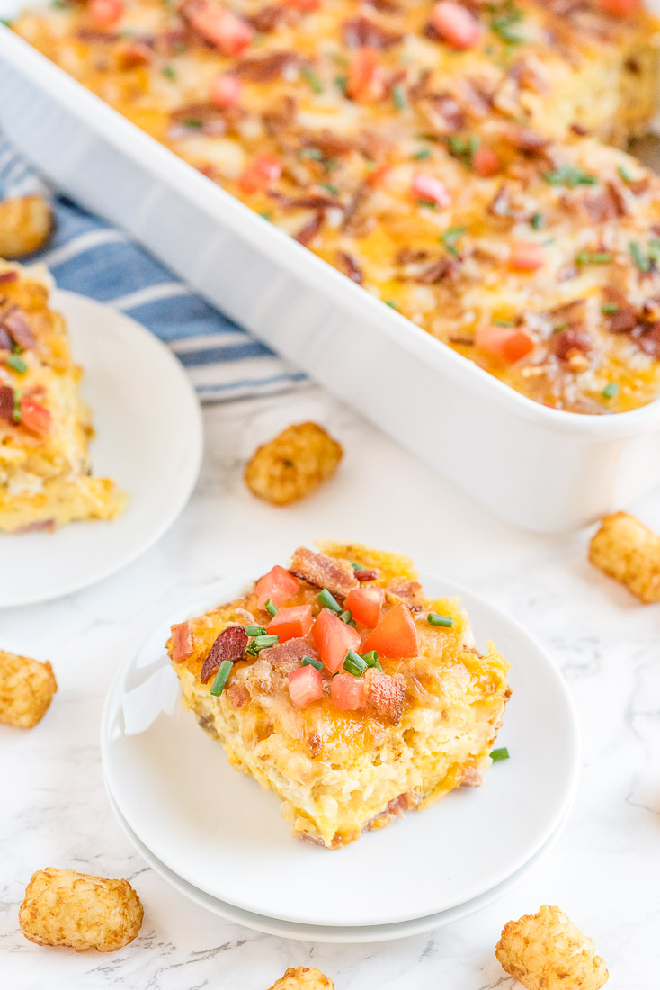 A piece of Tater Tot Breakfast Casserole on a white plate. 