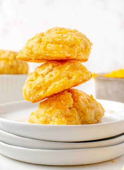 Three Cheese Drop Biscuits stacked on top of each other.