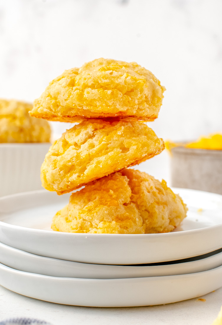 Three Cheese Drop Biscuits stacked on top of each other.