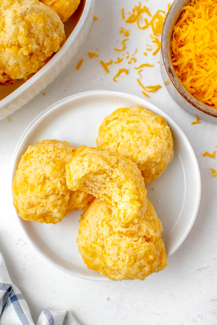 Four Cheese Drop Biscuits on a white plate. 