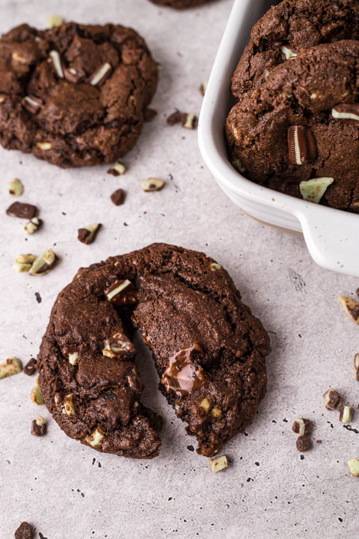 A finished Chocolate Andes Mint Cookie broken in half so you can see the fudge interior.