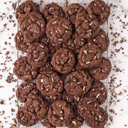A pile of Chocolate Mint Cookies on a wire cooling rack.