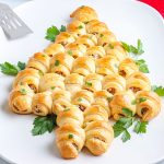 A close up picture of the finished Crescent Roll Christmas Tree on a white platter.