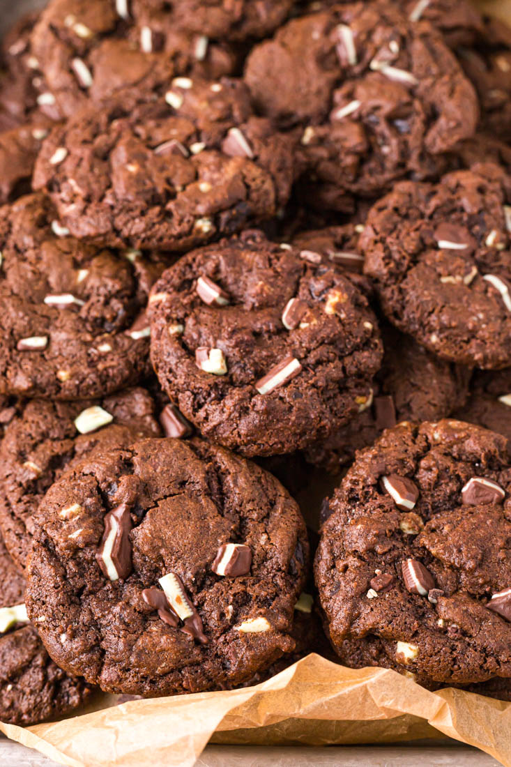 A close up picture of a pile of double chocolate mint cookies in a serving dish.