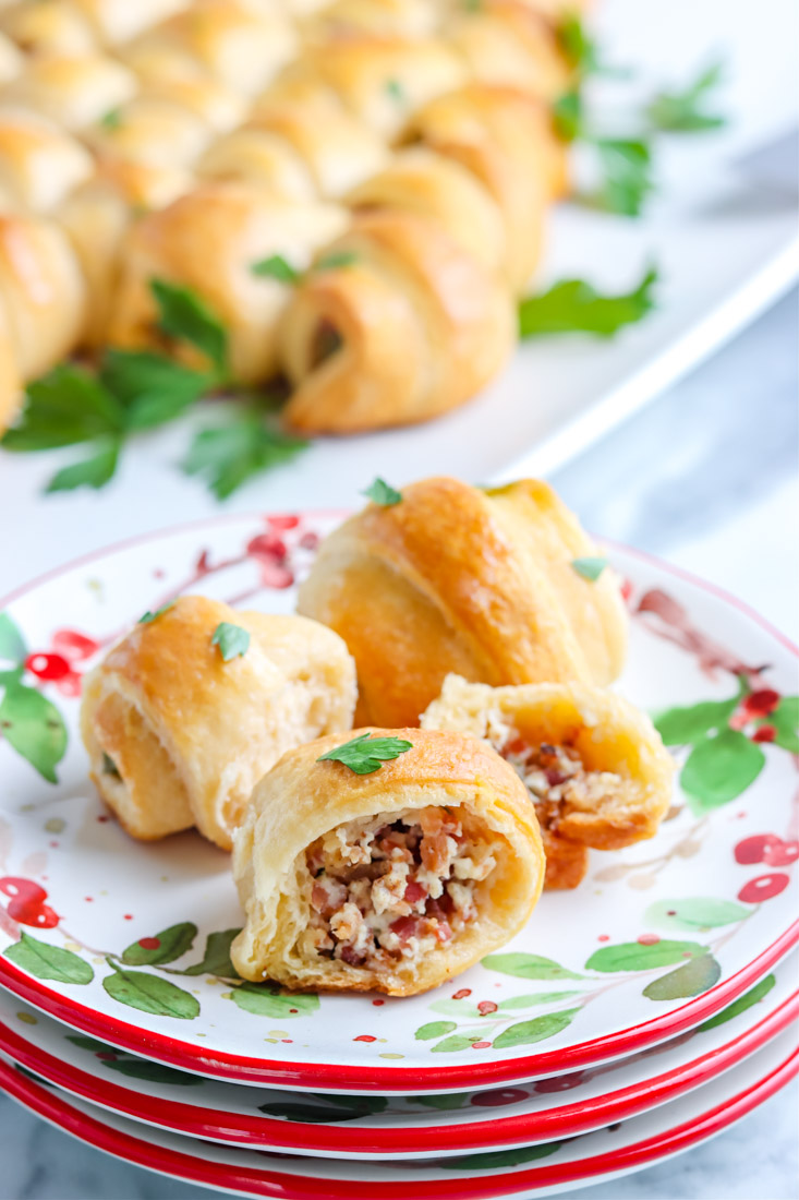 A close up picture of a piece of the Crescent Roll Christmas Tree cut in half so you can see the bacon and cream cheese filling.