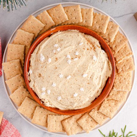 A close up picture of the finished Gingerbread Cheesecake Dip in a wooden serving bowl.