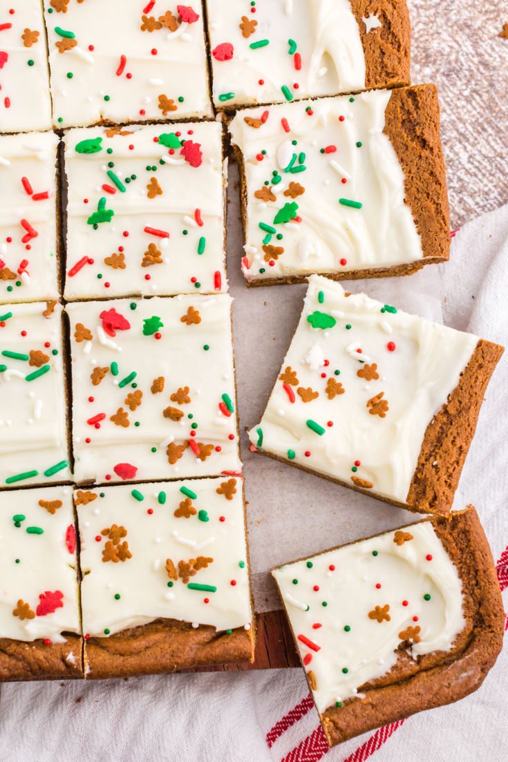 An overhead picture of the cut up Gingerbread bars with cream cheese frosting and sprinkles on them.