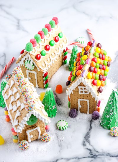Three Graham Cracker Gingerbread Houses all decorated differently to give you decorating ideas.