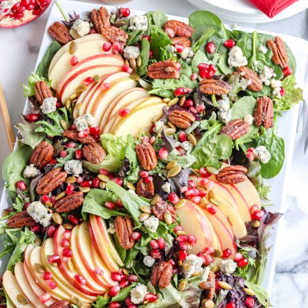 A close up picture of the finished Pomegranate Salad recipe on a white platter.