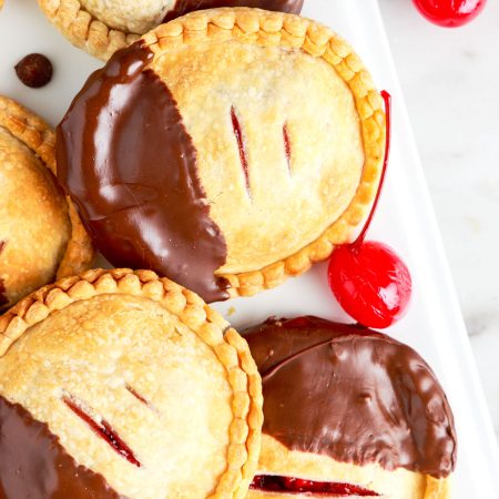 A close up overhead picture of the finished Air Fryer Cherry Hand Pies that have been dipped in chocolate.