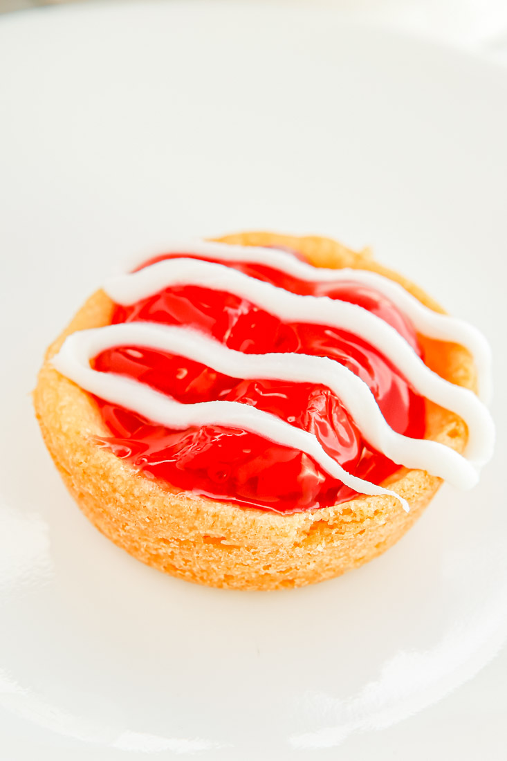 A close up picture of a finished cherry pie filling cookie.