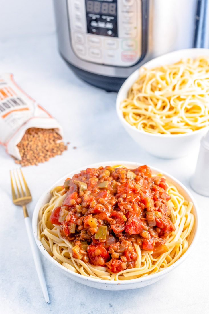 The finished Lentil Bolognese made in an Instant Pot served over pasta. 