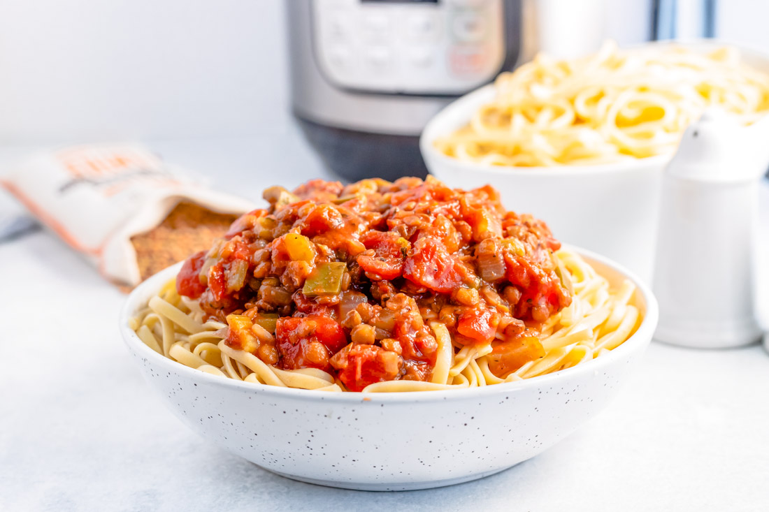 A bowl full of Instant Pot Lentil Bolognese over pasta.